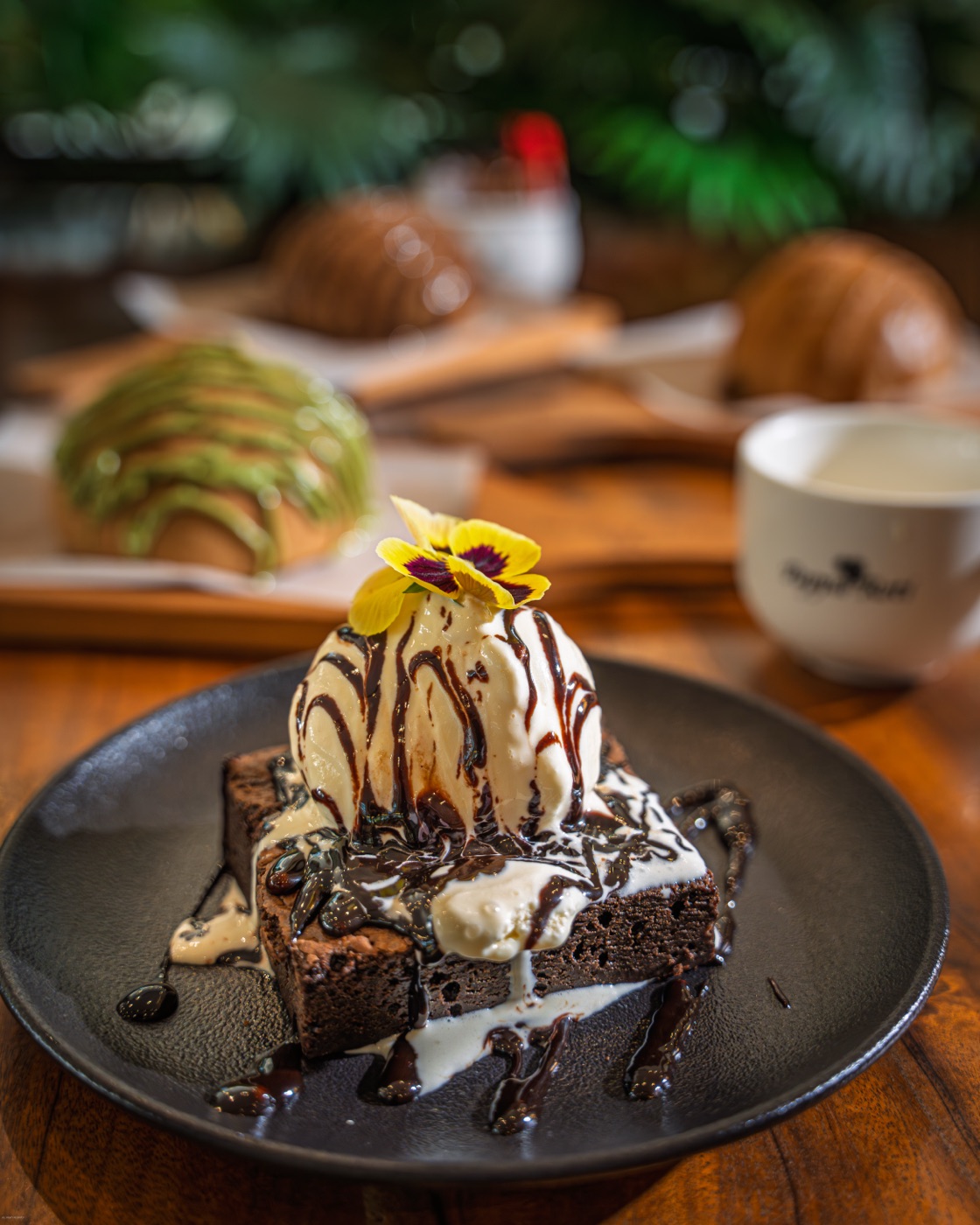 Brownie sundae with pastries behind