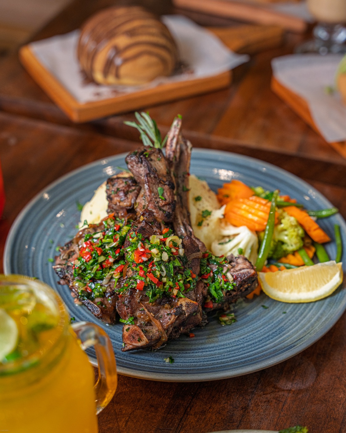 Grilled lamb chops with vegetables and a drink