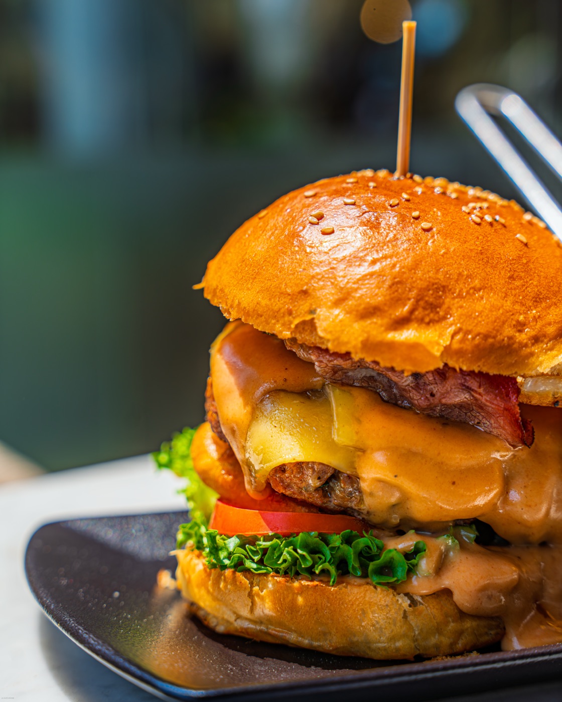 Tall cheeseburger with a skewer