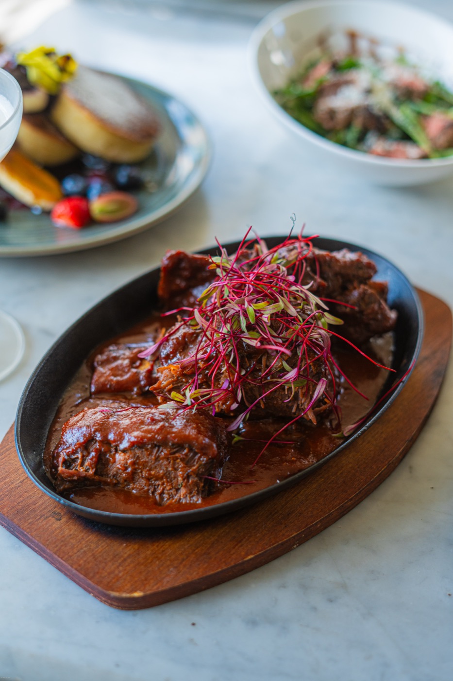 Sizzling steak with pickled onions