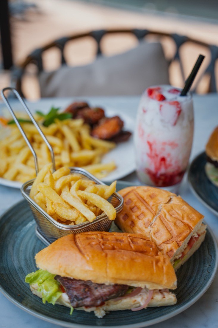 Burger, wings, and a berry drink spread