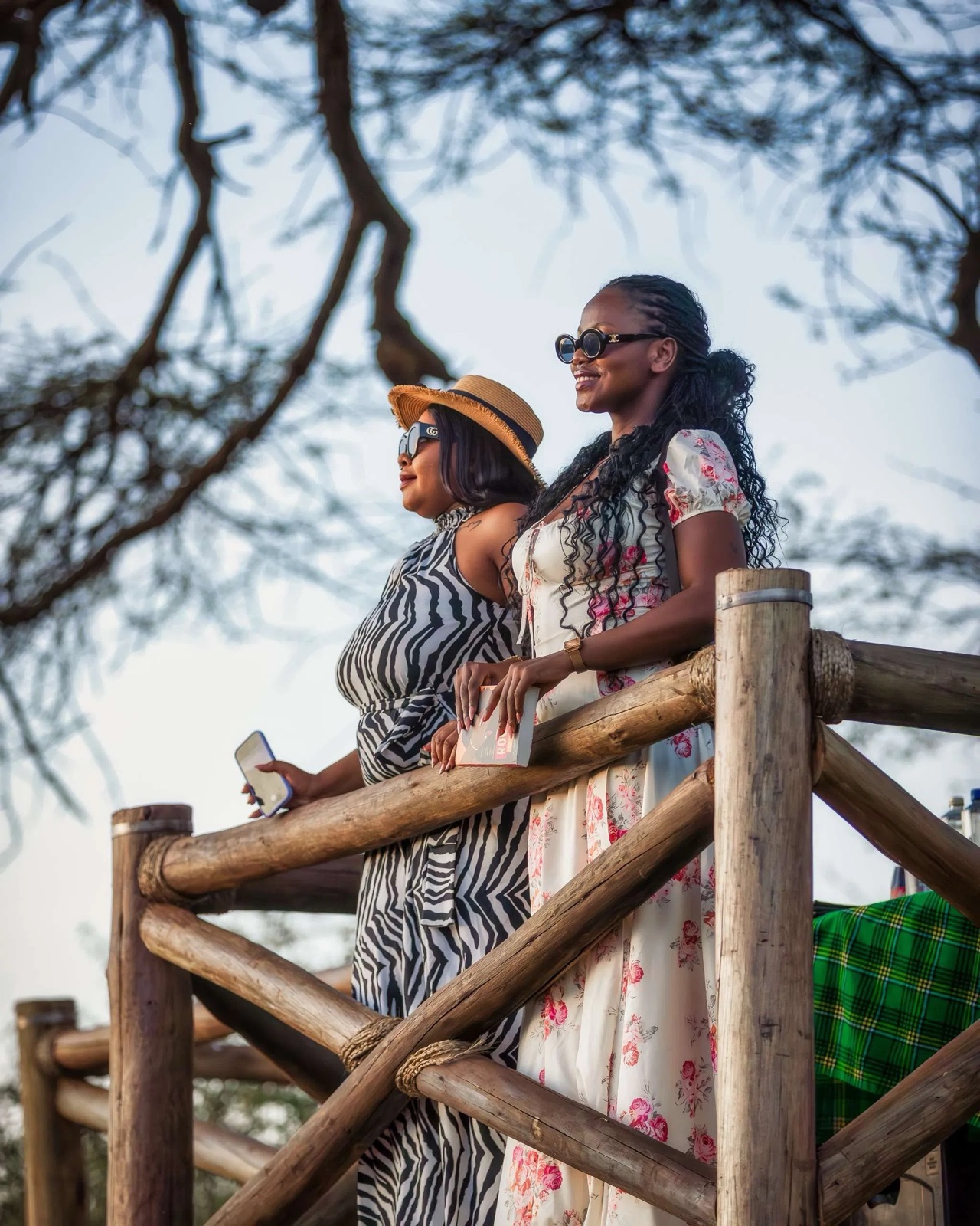 Two guests looking out from a wooden lookout