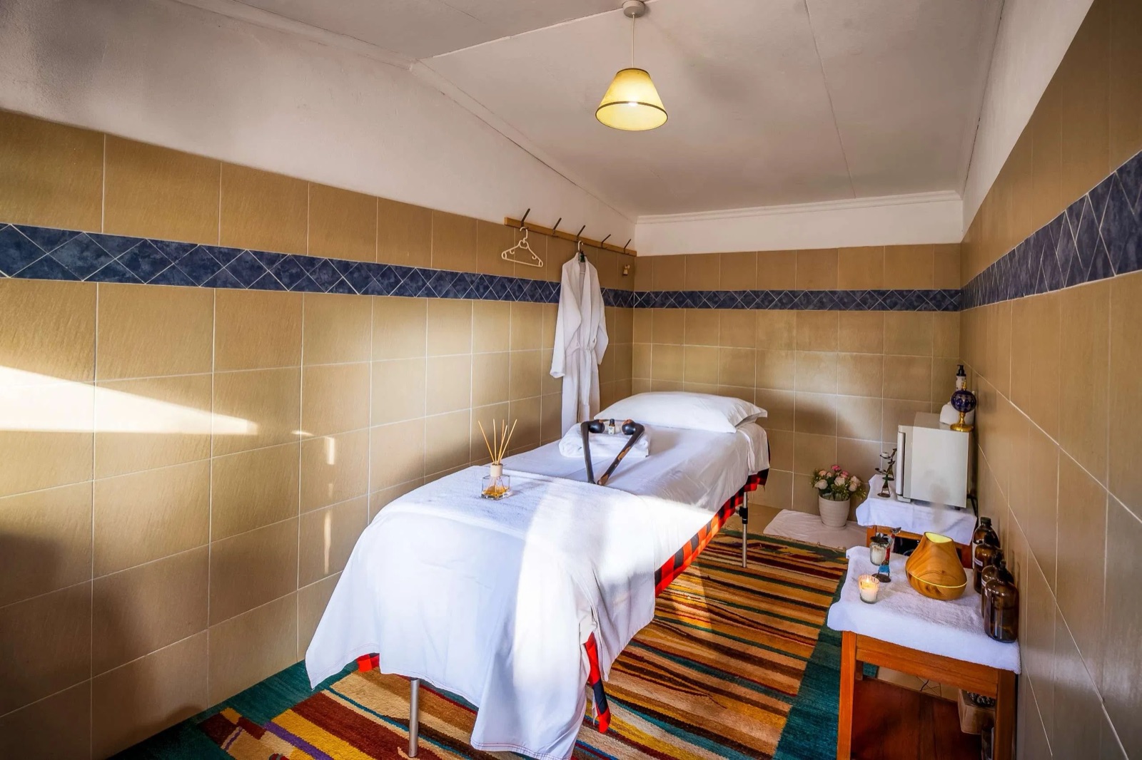 Spa treatment room with a dressed massage table